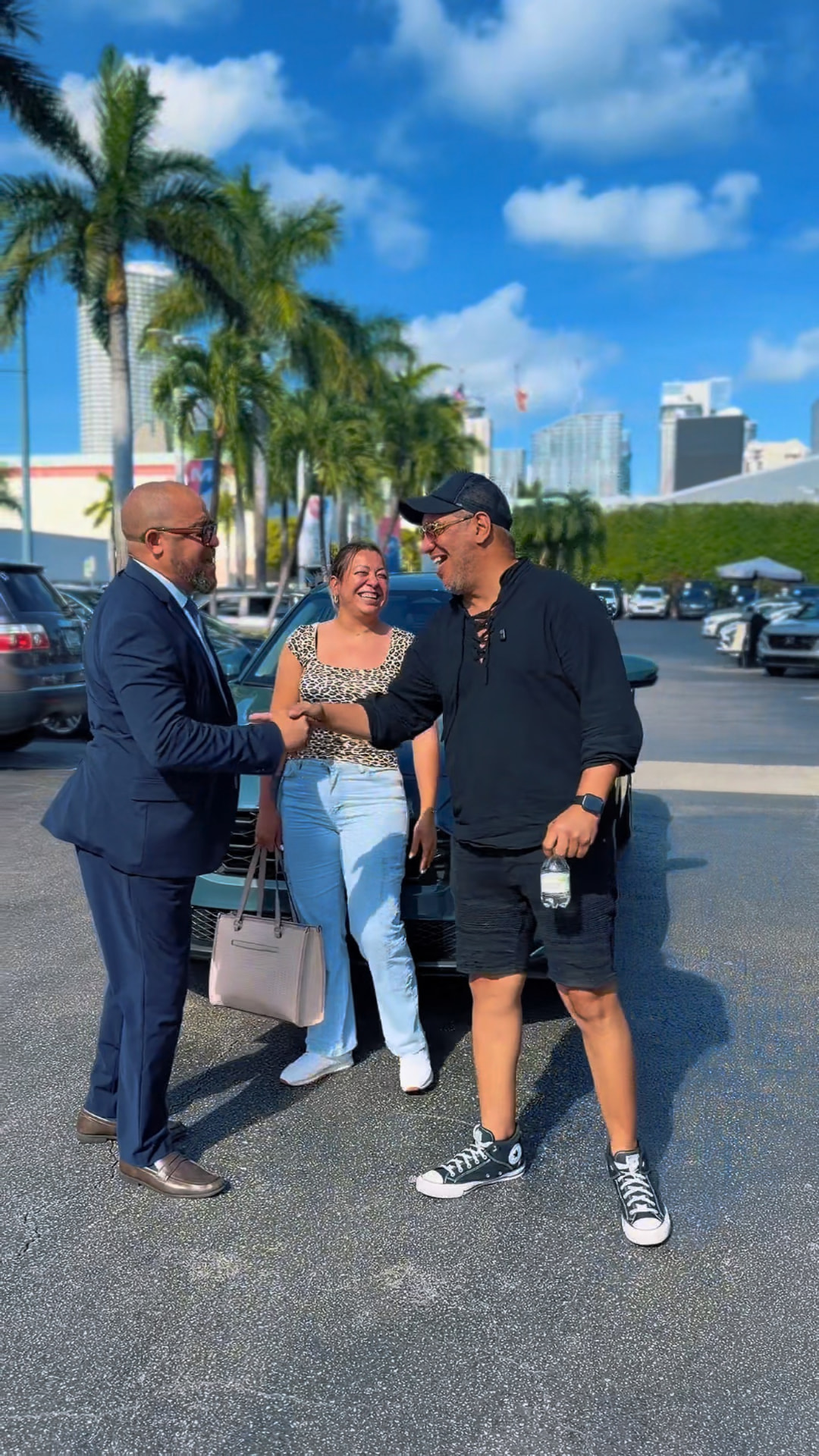 Alexander Montalvo shaking hands with customers after a delivery in Miami